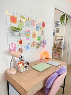 a wooden desk topped with a purple chair next to a wall covered in magnets