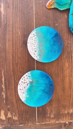 two blue plates sitting on top of a wooden table