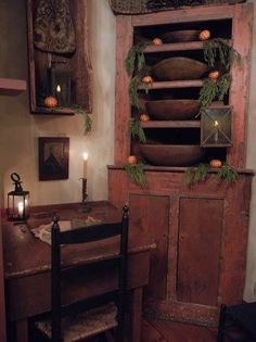 an old wooden cabinet with candles in it