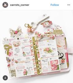 an open planner book with pink flowers and gold trimmings on the pages is shown