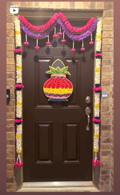 the front door is decorated with flowers and fruit for an entrance to a house or office