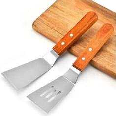 two knives and a cutting board on a white background