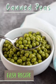 a white bowl filled with peas on top of a table