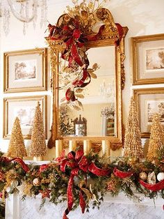 a mantel decorated for christmas with gold and red decorations