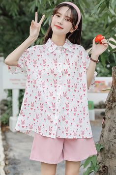 Boxy short sleeve blouse with pink rabbits, bows and flowers. S: 43" chest, 26" lengthM: 44.5" chest, 26" lengthL: 46" chest, 26.5" lengthXL: 47.5" chest, 26.5" length Pink Rabbit, Pink Bunny, Shoe Gifts, Overall Dress, Sweater Blouse, Cardigan Jacket, Short Sleeve Blouse, Shirt White, Button Up Shirt