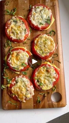 tomatoes with cheese and herbs on a cutting board