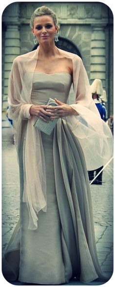 a woman in a gray dress and white shawl