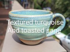 a close up of a cup on a table with the words textured turquiose and toasted sage