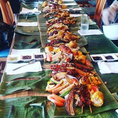 a long table with many different types of food laid out on top of each other