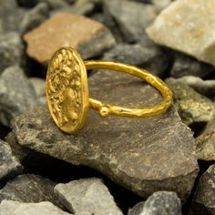 Ancient Roman Art Signed Coin Ring made 24k gold plated 925 sterling silver and used Reproduction Bronze Coin. Our shop offer free ring sizing. Handcrafted hammered full round ring band size measures 2 mm in width and 24k gold plated bronze coin 20x20 mm. Metal : 925 Sterling Silver Band Width : 2 mm Coin : Reproduction Bronze Coin Coin Size : 20x20 mm Ring Weight : 6.25 grams Ring Size : US 6 (The size you want is made for free). (We used the US standard sizing) **Custom Orders is Made** As pel Gold Hammered Ring As Gift, Gold Byzantine Hand Forged Rings, Hammered Gold Round Ring, Gold Byzantine 22k Rings, Gold Byzantine Ring, Hallmarked, 22k Gold Byzantine Rings, Gold 22k Byzantine Rings, Handmade Gold Byzantine Rings, Gold Byzantine Rings For Anniversary