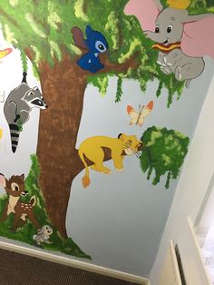 a child's room wall mural with animals and trees on the bottom half of it