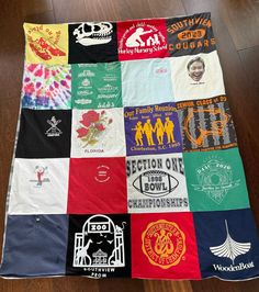 a quilt made out of t - shirts on the floor