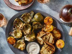 grilled artichokes on a plate with ranch dressing