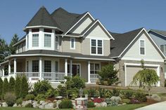 a large house with lots of windows and landscaping