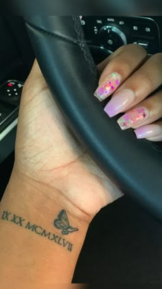 a woman's hand with a butterfly tattoo on her wrist and the words dixie mcm