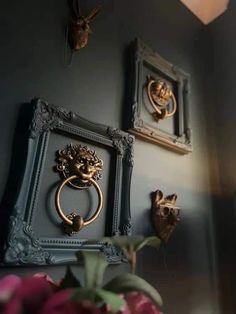 there are two pictures on the wall and one has a door knocker