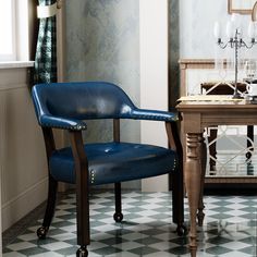 a blue chair sitting in front of a table