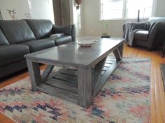 a living room with leather couches and a coffee table in the middle of it