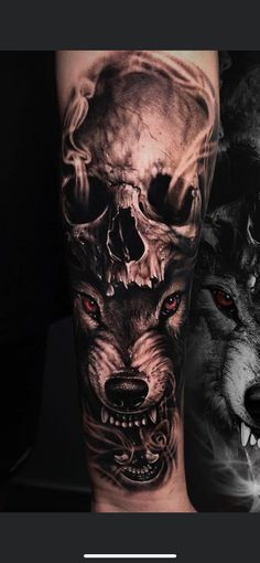 a man's arm with two wolfs and a skull on it