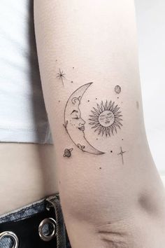 a woman's arm with a tattoo on it that shows the moon and stars