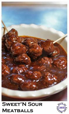 the meatballs are being served with toothpicks