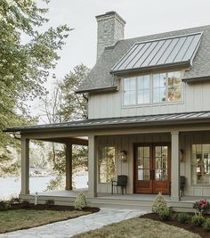 a small house with a porch and covered patio