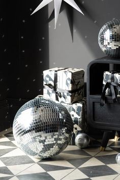 disco balls and boxes on a black and white checkerboard floor with a star above them