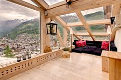 a living room filled with furniture next to a large window covered in wooden framers