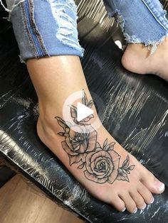 a woman's foot with a rose tattoo on it