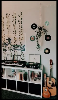 a living room with guitars, music equipment and wall decorations