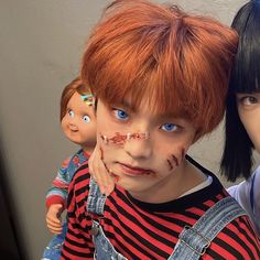 two children with fake heads and makeup on their faces are posing for a photo together