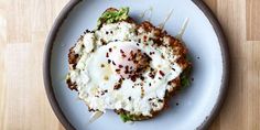 an egg is on top of some toasted bread with lettuce and other toppings