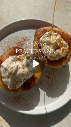 a white plate topped with two pieces of bread covered in whipped cream