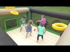 three children playing in an inflatable bounce house