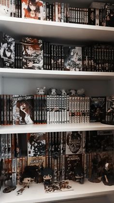 the shelves are filled with many books and dvds, all in black and white colors