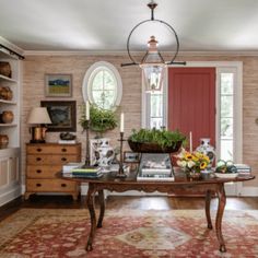 a living room filled with lots of furniture and decor on top of a wooden floor