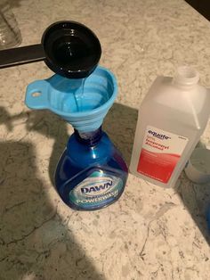 a counter top with two bottles and a soap dispenser