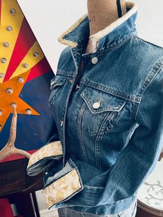 Embrace the beauty of the Southwest with J. Co.'s Desert Sunsets One of a Kind Western Upcycled Denim Jacket. This jacket is meticulously crafted from high-quality, sustainably sourced denim, featuring unique sunset-inspired artwork that captures the vibrant hues of the desert landscape.  Perfect for adding a touch of Western charm to any outfit, this jacket is both stylish and made with sustainable fashion in mind. Stand out from the crowd while making a statement for the planet.  Reworked West Fitted Denim Jacket For Rodeo, Fitted Western Denim Jacket For Rodeo, Fitted Western Denim Jacket, Fitted Western Outerwear For Spring, Fitted Western Spring Outerwear, Fitted Western Style Outerwear For Spring, Fitted Western Style Spring Outerwear, Western Style Fitted Medium Wash Outerwear, Fitted Western Dark Wash Denim Jacket