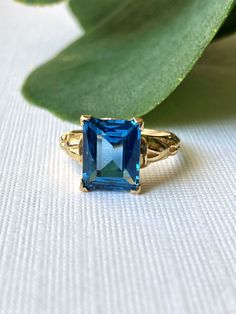 Beautiful rich blue gemstone vintage ring. The color of the blue is absolutely dazzling! The ring dates to the 1940s - 1960s approximately.  Solid 10K yellow gold. Emerald cut gemstone that tests as topaz on my at-home SmartPro Gem Tester but looks like it could be blue spinel, especially judging by the older setting and the high hardness rating.  Signed and tested real 10K gold. Size 5 US; resizable by your local jeweler.  Measures 10 mm tall, see all photos. Main photo is enlarged/zoomed-in to show you details. In great used, vintage pre-owned condition. Slight rattle when shaken but the stone is secure and in lovely condition for its age. Light normal patina/wear to mount.  See you on Instagram @luxcharmjewelry xo 10k Gold Ring, Blue Spinel, Spinel Gemstone, Blue Gemstones, Vintage Ring, 10k Gold, Emerald Cut, Rings Statement, Vintage Rings