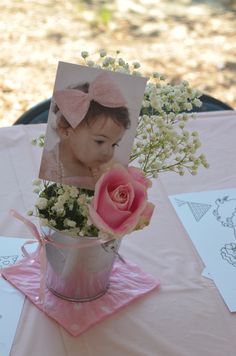 a pink and gold photo frame with baby's breath flowers in a flower pot