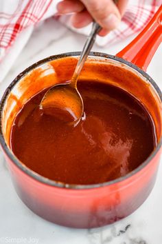 a person stirring chocolate into a saucepan