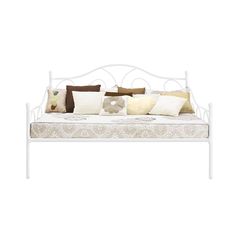 a white daybed with pillows on top of it and an arm rest in the middle