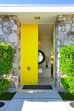 a yellow door is in the entry way