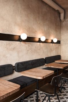 an empty restaurant with wooden tables and chairs