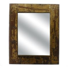 a mirror that is sitting on top of a white wall and has rusted metal frame