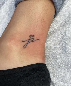 a woman's foot with a tattoo that reads f and is on the side