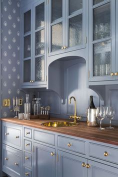 the instagram page on instagram shows an image of a kitchen with blue cabinets and gold accents