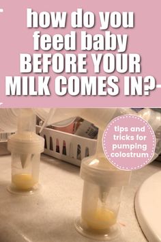 two baby bottles filled with milk sitting on top of a counter