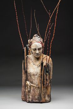 a wooden sculpture with branches sticking out of it