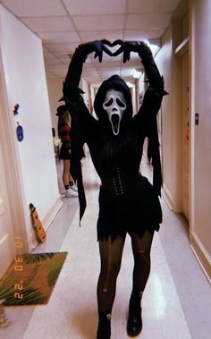 a woman dressed as a skeleton with her arms in the air